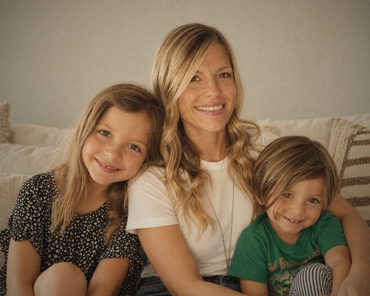 Afton, founder of Best Day Ever Kids, on a couch at home with her daughter and son
