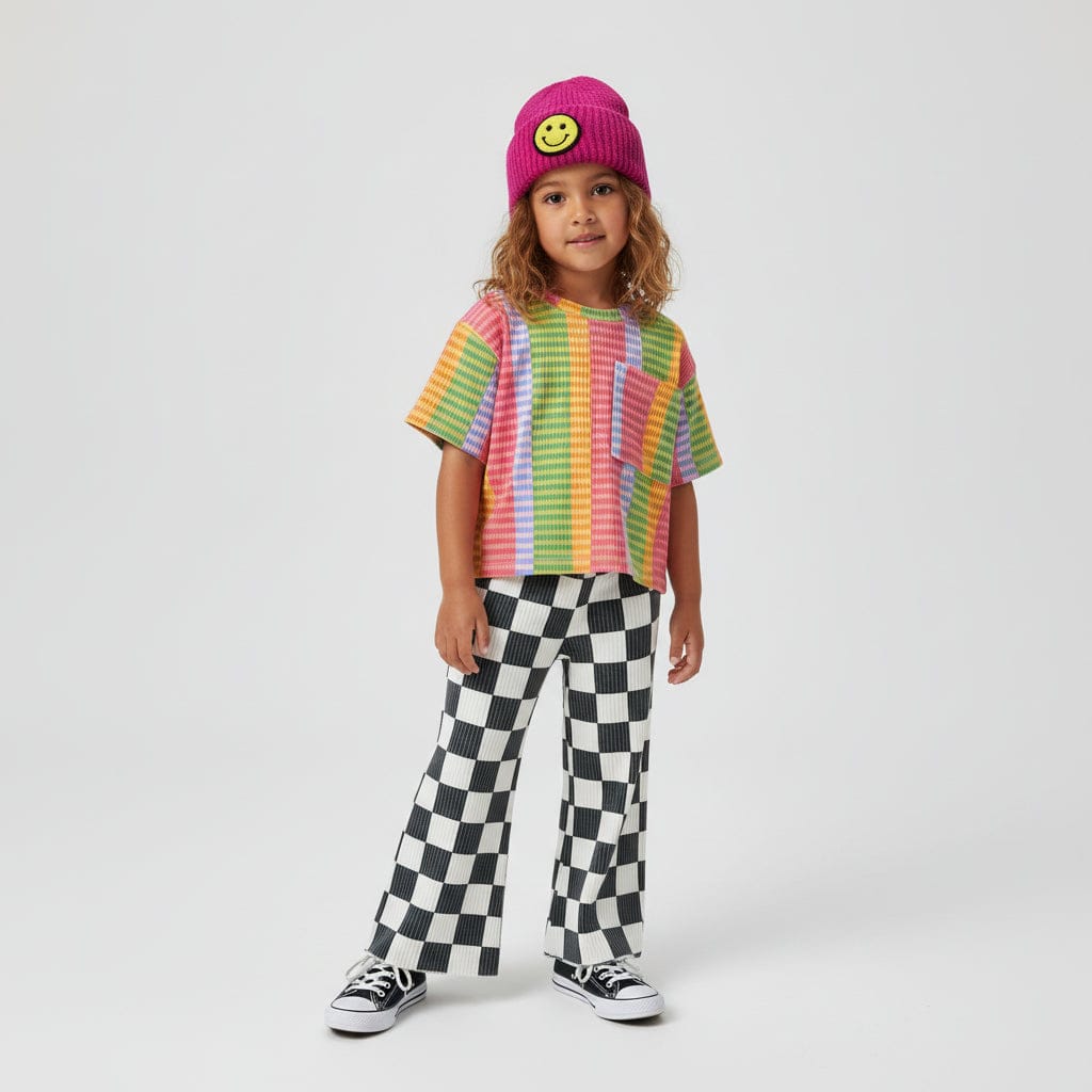 Kid in a pink beanie and rainbow stripe tee wearing Checked Out Wide Leg Pants