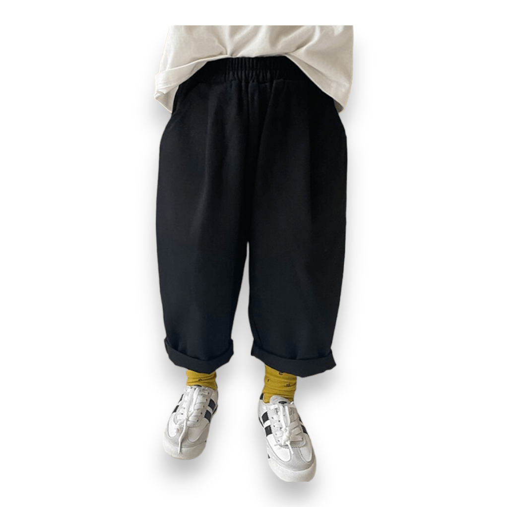 City Kid Baggy Pant in black, worn cuffed with mustard socks and white sneakers, front view