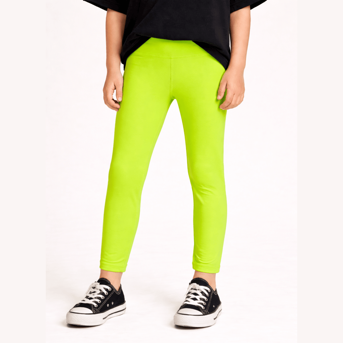Electric Lime Foil Leggings worn with a black top and sneakers