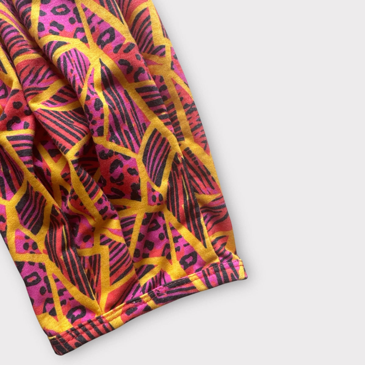Close-up of the Neon Jungle print at the ankle cuff