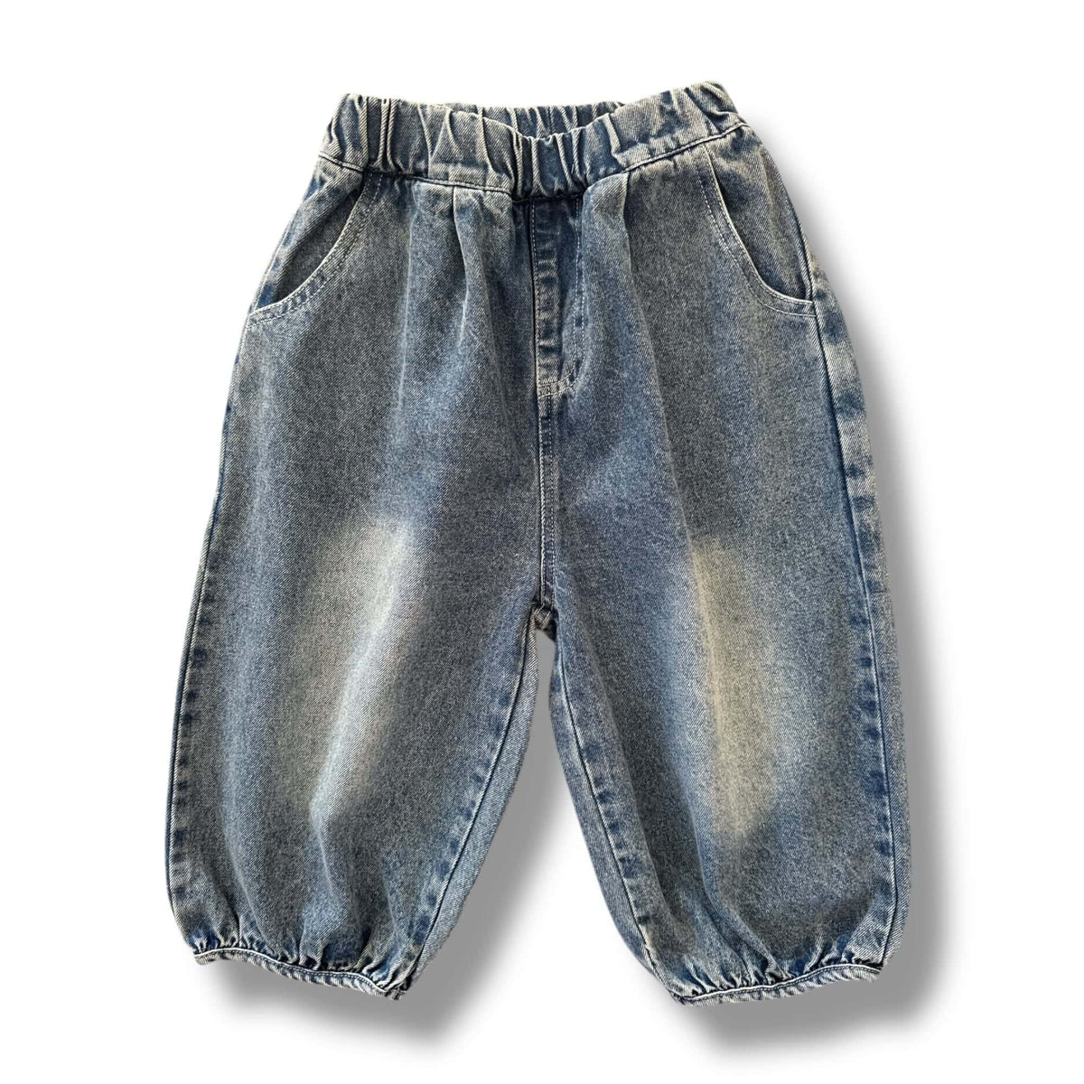 The Denim Jogger in light vintage-wash denim, laid flat, front view