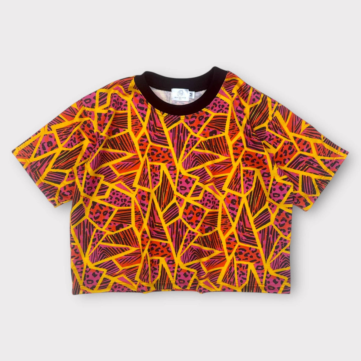Neon Jungle Oversized Tee, magenta and orange geometric print, laid flat