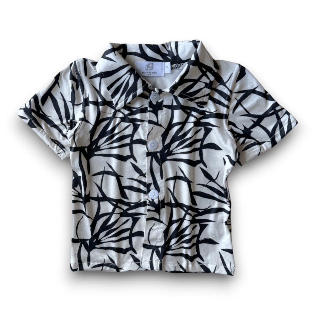 Snazzy Button Down in the Palm Beach print, black palm-leaf brushstrokes on white, laid flat