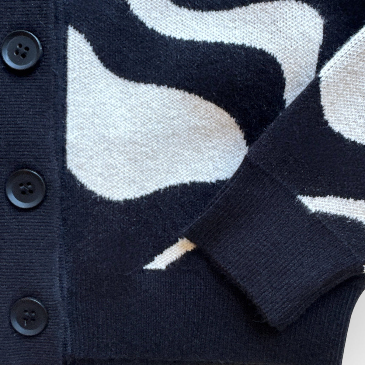 Close-up of the Trippy Tide Cardigan's button front