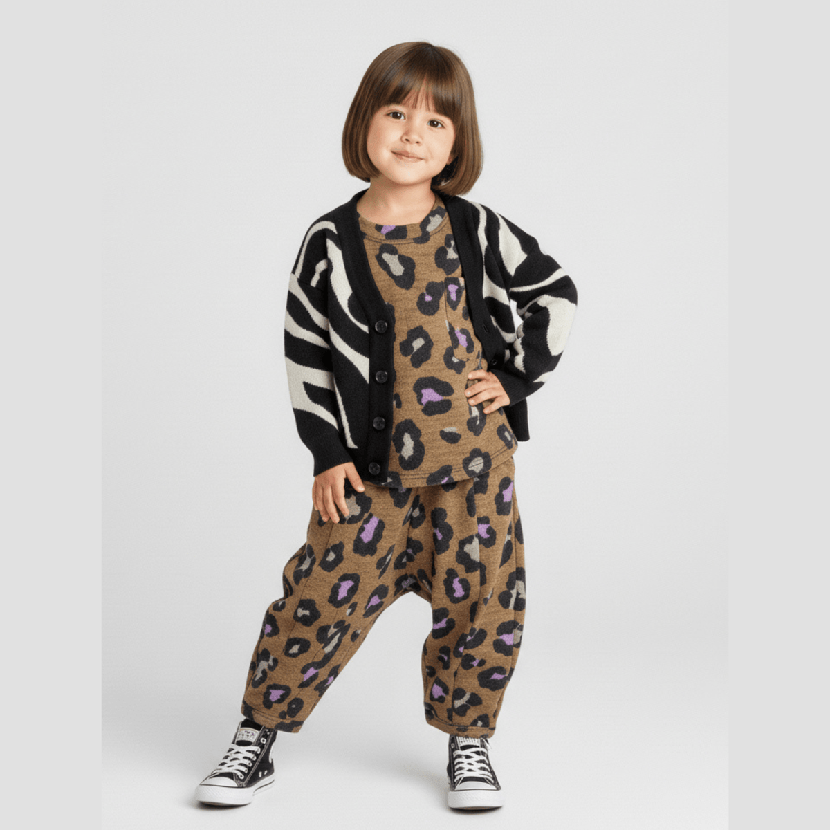 Kid in a zebra cardigan wearing the matching Lazy Leopard tee and pant