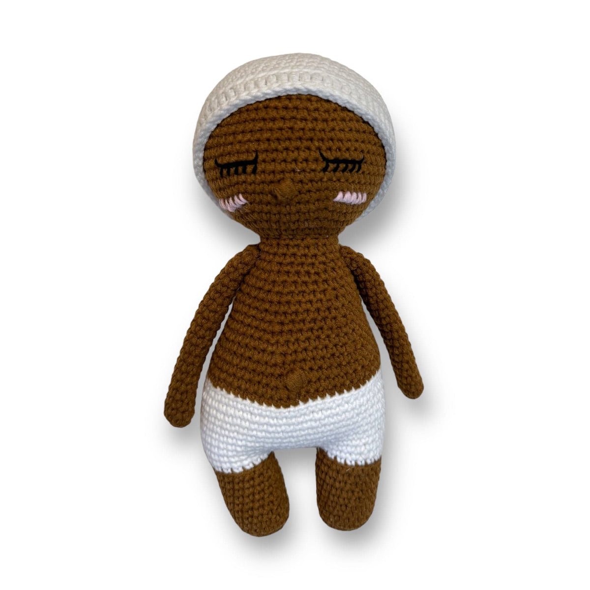Hand-crocheted baby doll with brown skin and a white knit hat
