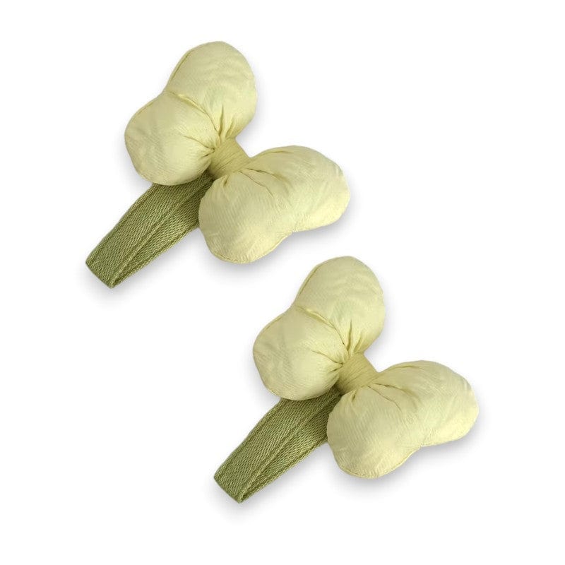Two puffy pale yellow bow hair clips