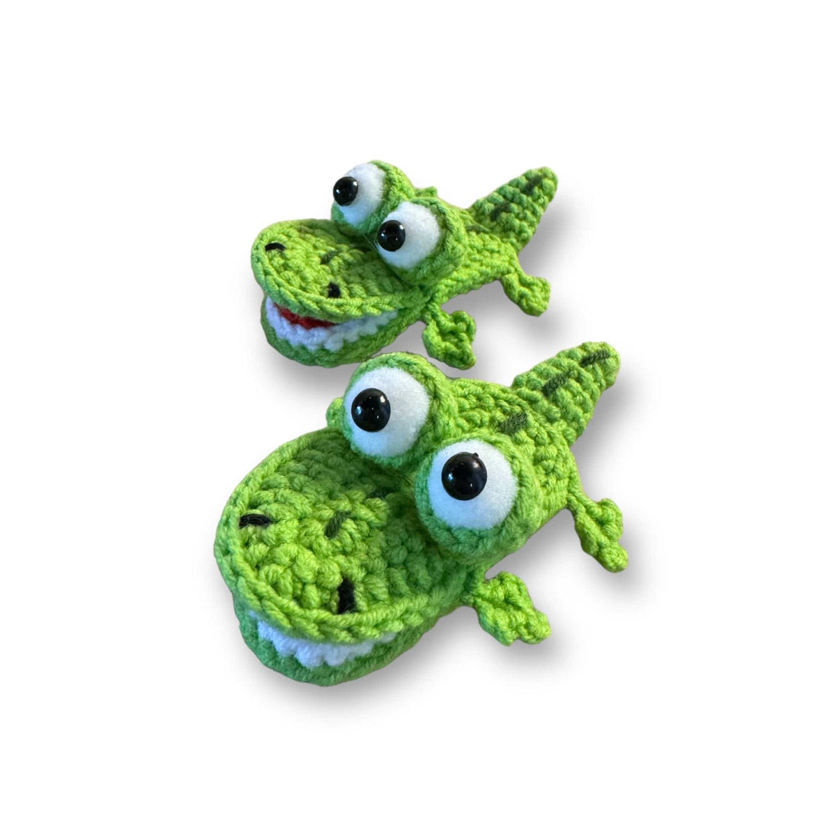 Hand-crocheted alligator hair clips, side view showing their toothy grins
