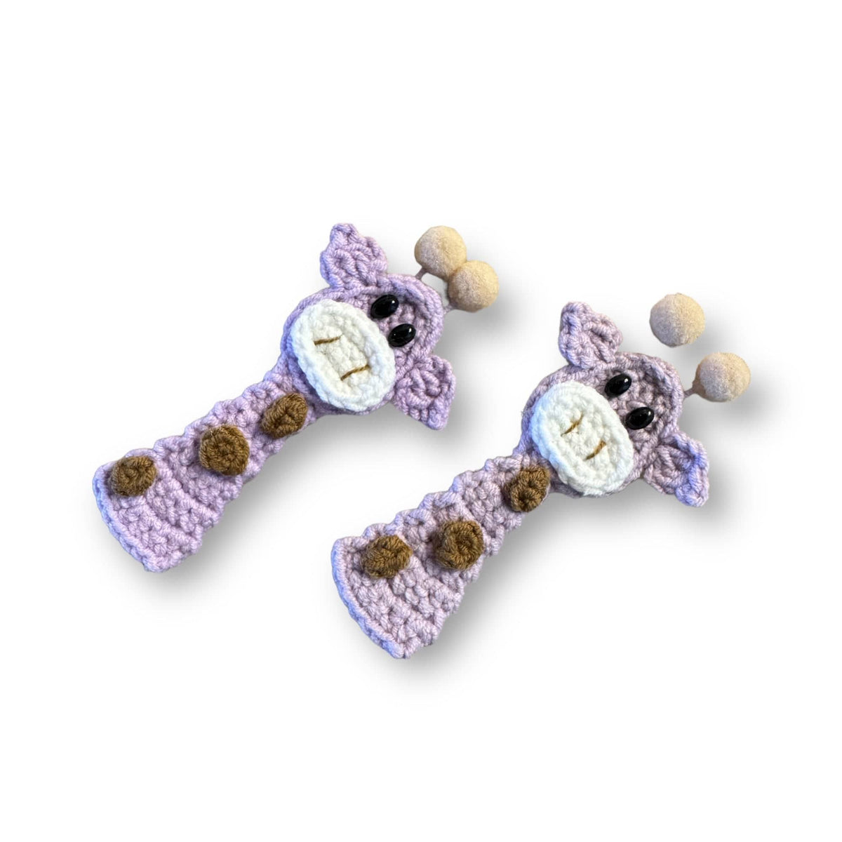 Two hand-crocheted lavender giraffe hair clips with felt ball horns