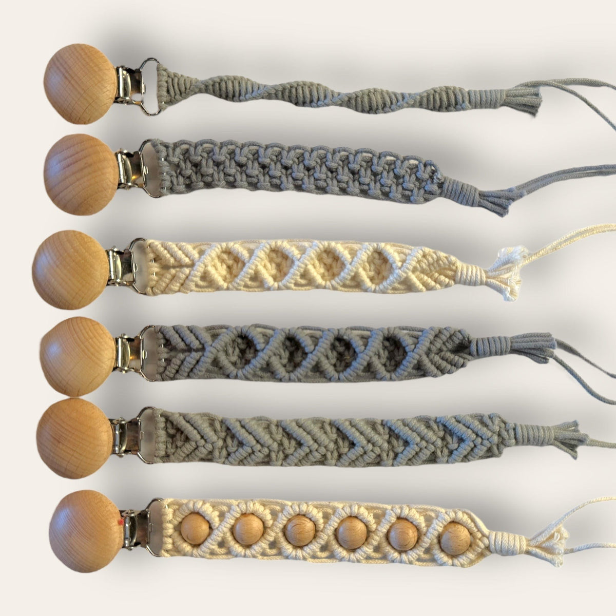 Six handmade macrame pacifier clips with beechwood clips in cream and gray