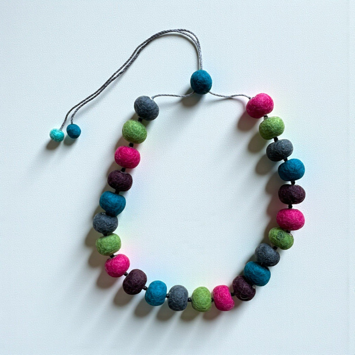 Felt bead necklace in pink, navy, green and plum