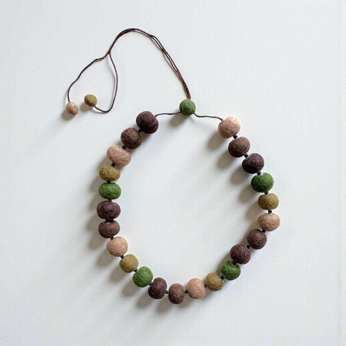 Felt bead necklace in earthy browns, greens and tan