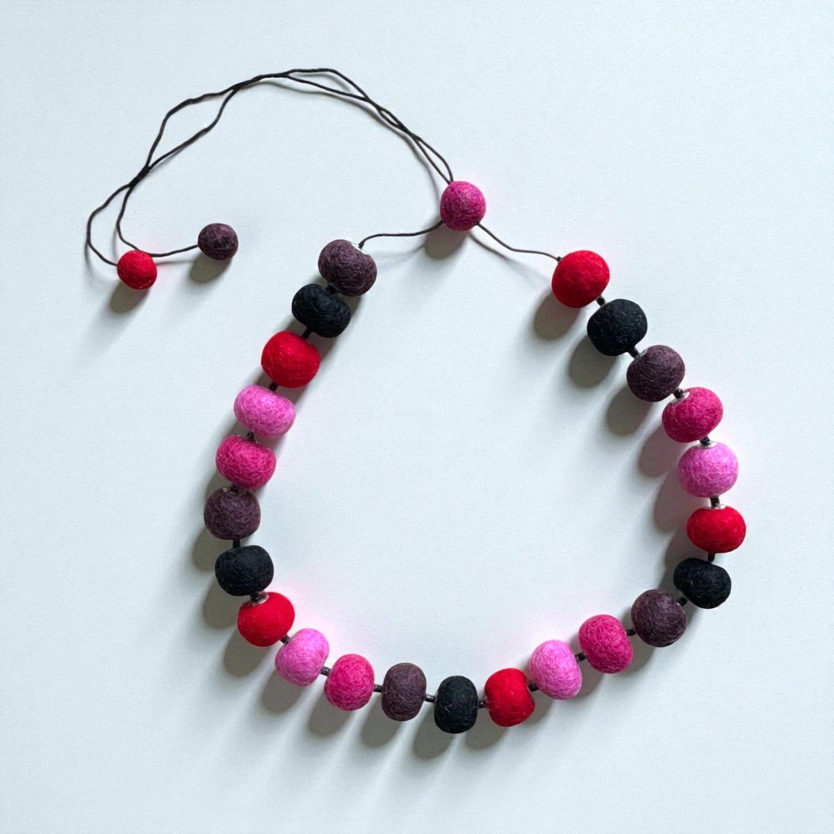 Felt bead necklace in pink, burgundy and black