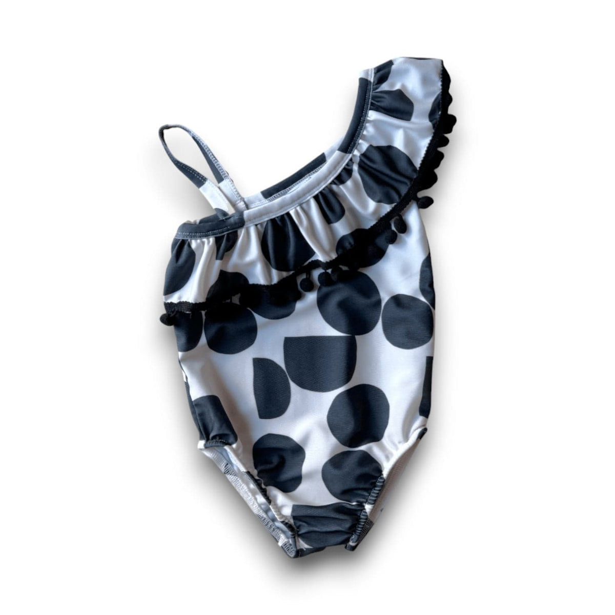 I Heart Pom-Poms one-shoulder swimsuit in the black-and-white Pop Rocks print, with a black pom-pom ruffle