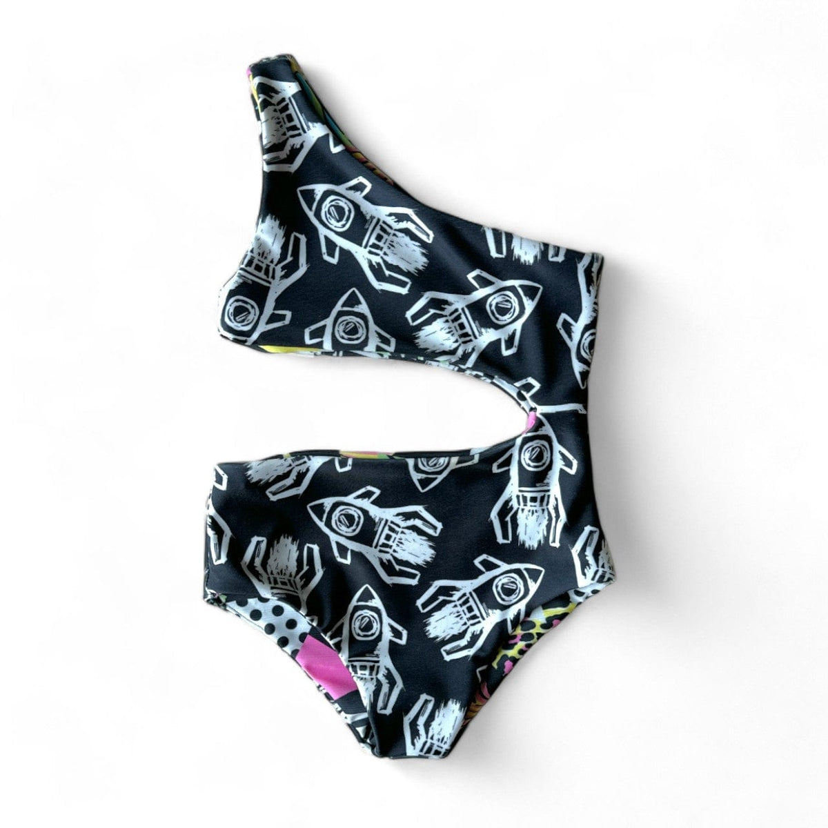 One Shoulder Reversible Swimsuit, Rad Rockets side: white rockets on black, laid flat