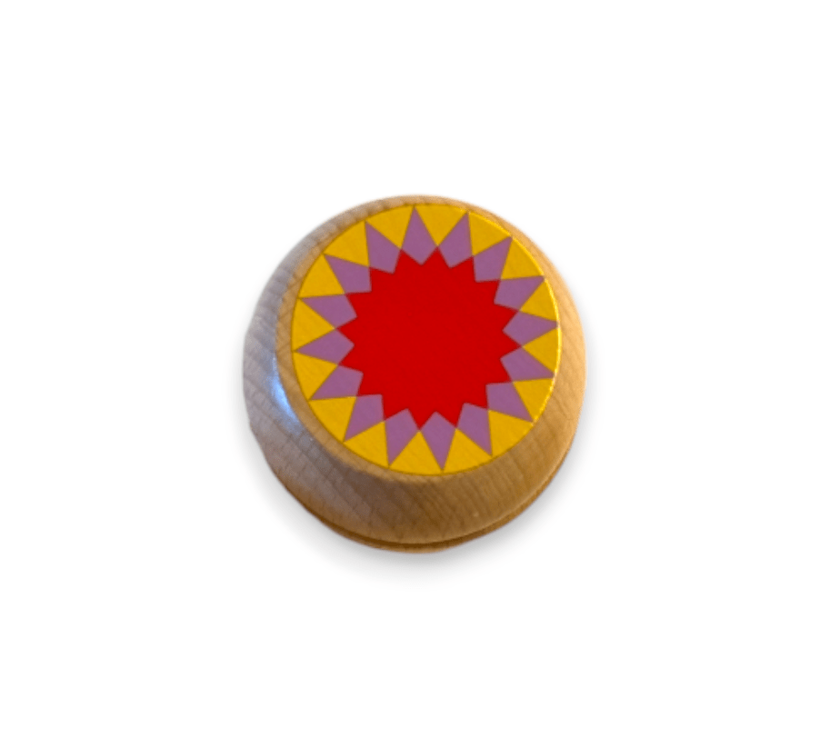 Wooden yo-yo with a red starburst on yellow