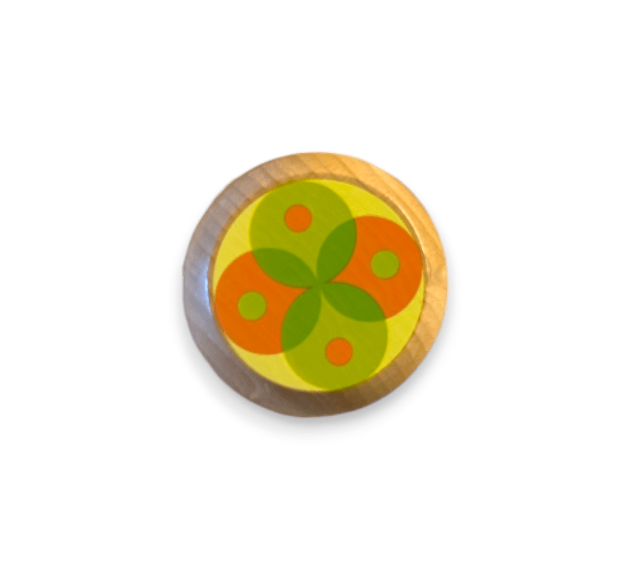 Wooden yo-yo with an orange and green flower pattern