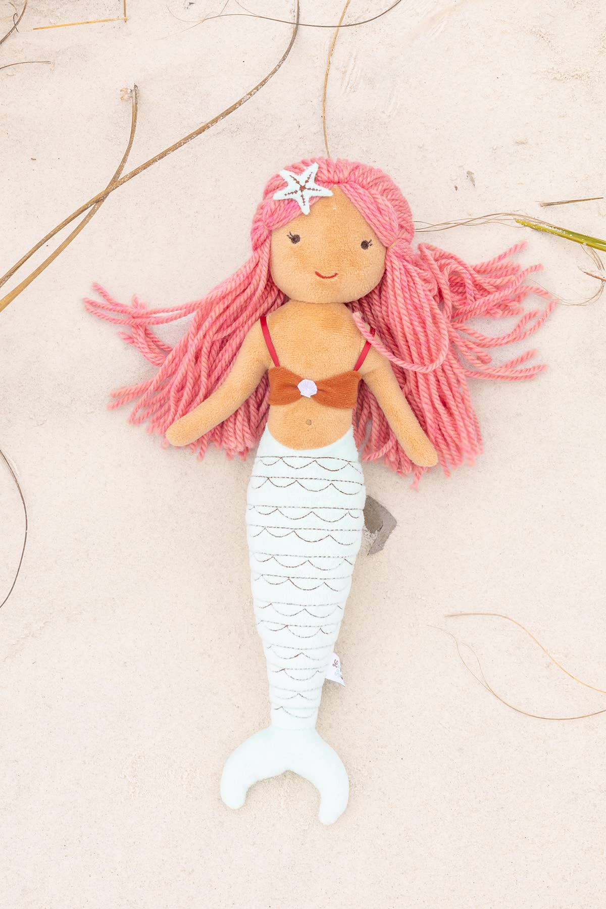 Cordelia the Mermaid lying on sand
