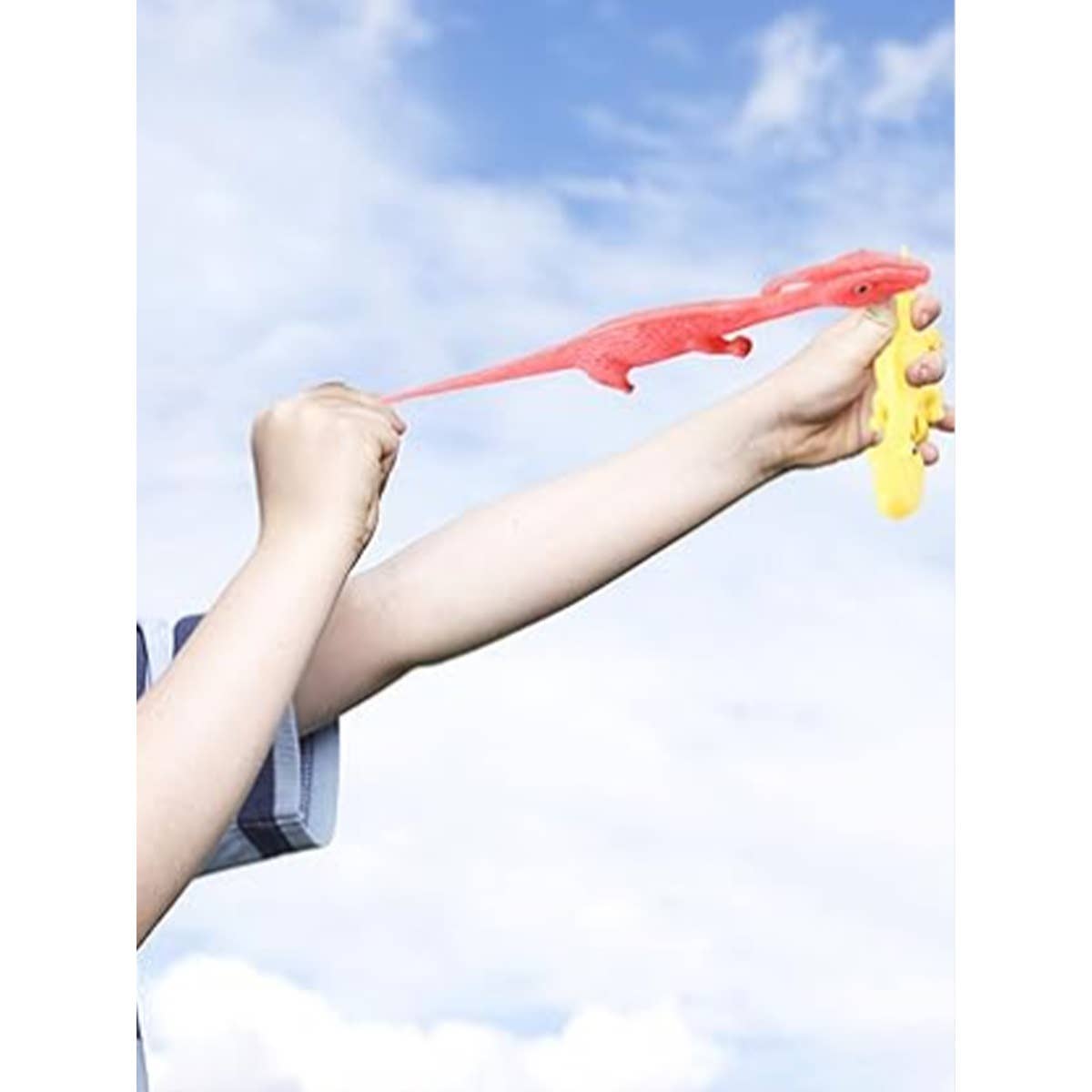 Pink stretchy dinosaur being launched against a blue sky