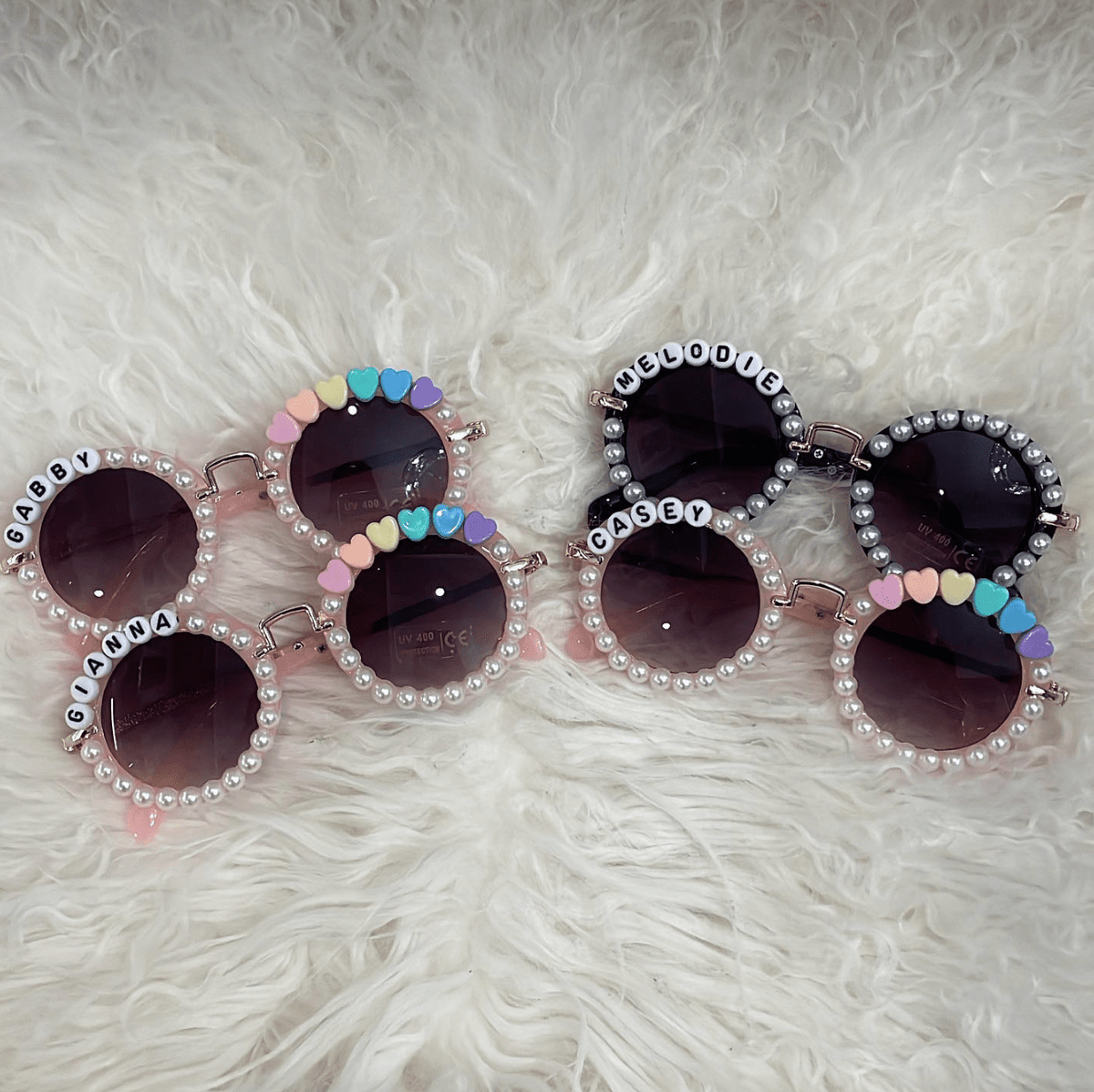 Pearl and heart personalized kids' sunglasses with names on the frames